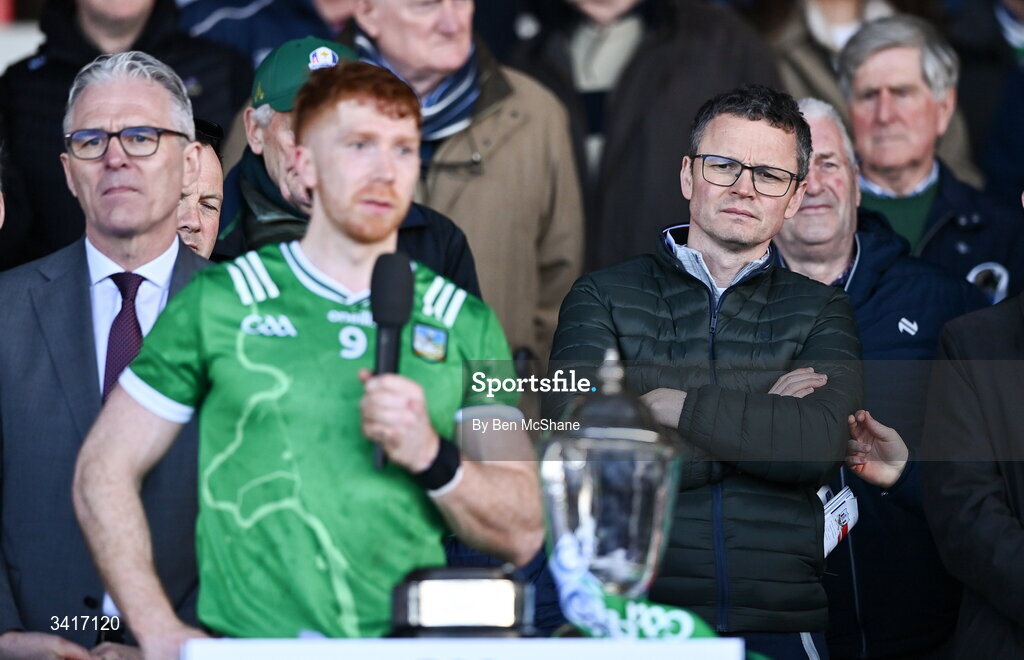 5 April 2026; Minister for Arts, Media, Communications, Culture and Sport Patrick O'Donovan TD looks on as Limerick captain Cian Lynch makes a speech after the Allianz Hurling League Division 1A final match between Limerick and Cork at TUS Gaelic Grounds in Limerick. Photo by Ben McShane/Sportsfile