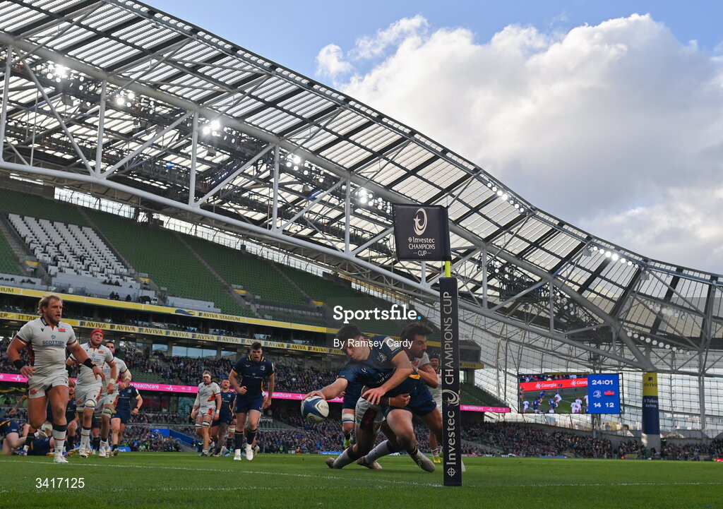 5 April 2026; Jimmy O'Brien of Leinster dives over to score his side's third try despite the attention of Charlie Shiel of Edinburgh during the Investec Champions Cup match between Leinster and Edinburgh at the Aviva Stadium in Dublin. Photo by Ramsey Cardy/Sportsfile