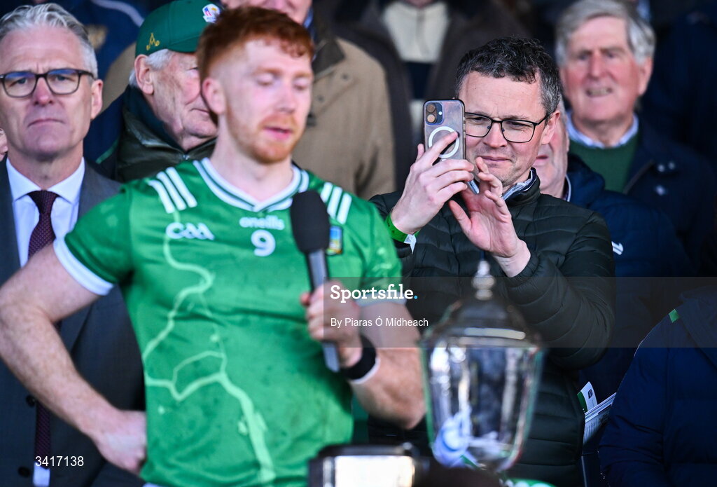5 April 2026; Patrick O'Donovan is the Minister for Arts, Culture, Communications, Media and Sport takes a picture as Limerick captain Cian Lynch makes a victory speech after the Allianz Hurling League Division 1A final match between Limerick and Cork at TUS Gaelic Grounds in Limerick. Photo by Piaras Ó Mídheach/Sportsfile