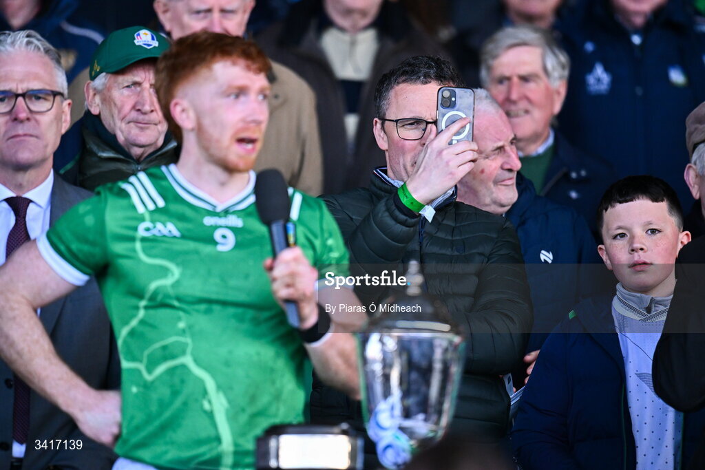 5 April 2026; Patrick O'Donovan is the Minister for Arts, Culture, Communications, Media and Sport takes a picture as Limerick captain Cian Lynch makes a victory speech after the Allianz Hurling League Division 1A final match between Limerick and Cork at TUS Gaelic Grounds in Limerick. Photo by Piaras Ó Mídheach/Sportsfile