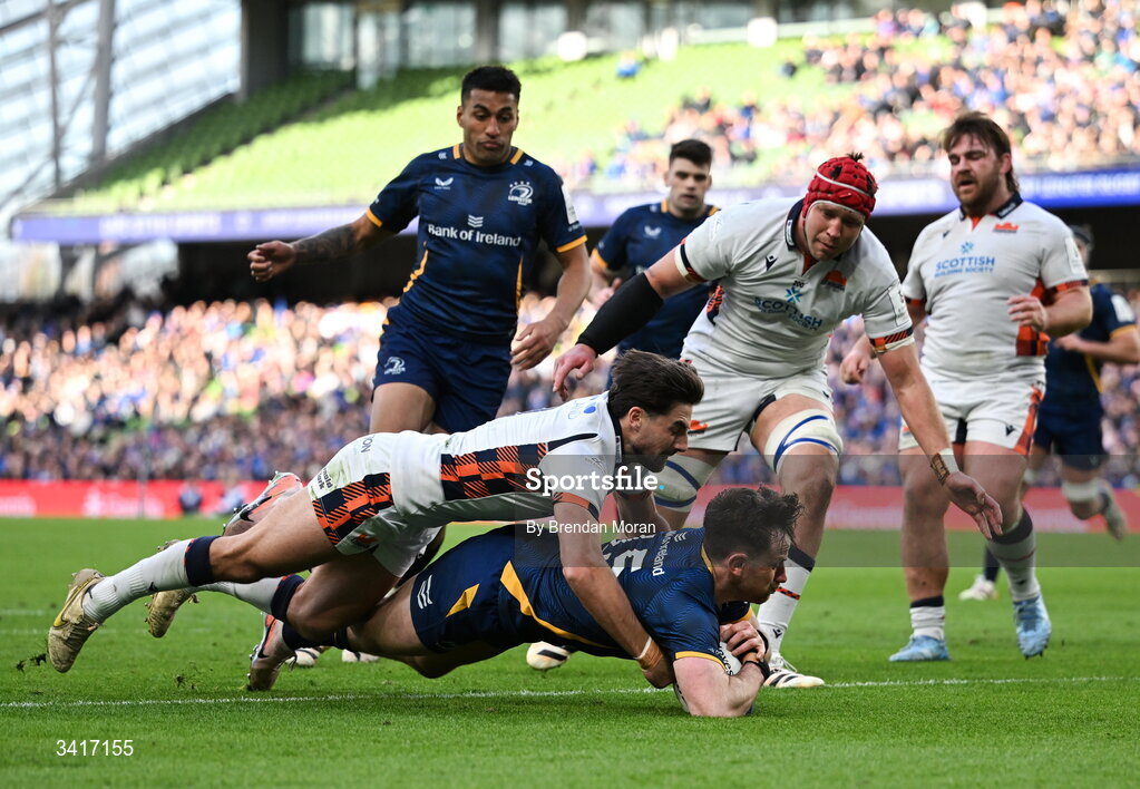5 April 2026; Hugo Keenan of Leinster is tackled by Charlie Shiel of Edinburgh on the way to scoring his side's fourth try during the Investec Champions Cup match between Leinster and Edinburgh at the Aviva Stadium in Dublin. Photo by Brendan Moran/Sportsfile
