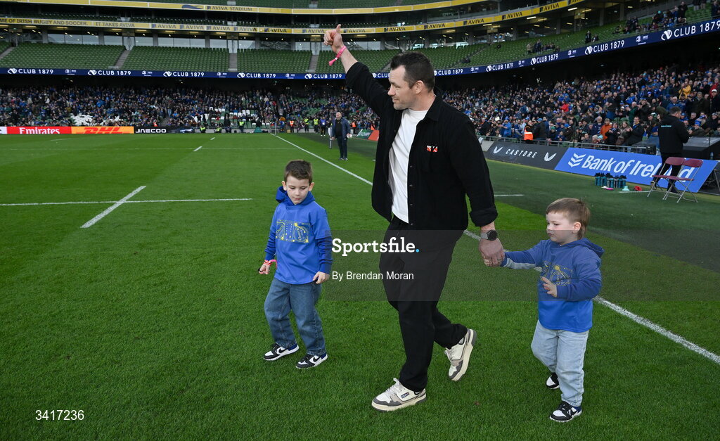 5 April 2026; Leinster record cap holder Cian Healy with his children Beau and Russell as he is introduced to the crowd for a presentation at half-time in the Investec Champions Cup match between Leinster and Edinburgh at the Aviva Stadium in Dublin. Photo by Brendan Moran/Sportsfile