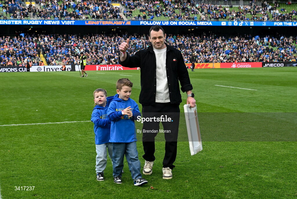 5 April 2026; Leinster record cap holder Cian Healy with his children Beau and Russell as he is introduced to the crowd for a presentation at half-time in the Investec Champions Cup match between Leinster and Edinburgh at the Aviva Stadium in Dublin. Photo by Brendan Moran/Sportsfile