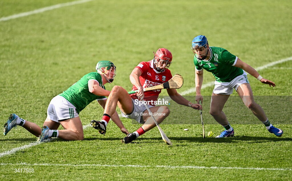 5 April 2026; Brian Hayes of Cork is tackled by Seán Finn, left, and Mike Casey of Limerick during the Allianz Hurling League Division 1A final match between Limerick and Cork at TUS Gaelic Grounds in Limerick. Photo by Ben McShane/Sportsfile