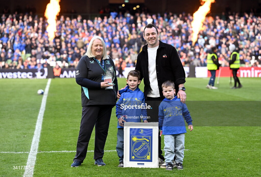 5 April 2026; OLSC committee member Mary Carroll makes a presentation to record Leinster cap holder Cian Healy, accompanied by his sons Russell and Beau, at half-time in the Investec Champions Cup match between Leinster and Edinburgh at the Aviva Stadium in Dublin. Photo by Brendan Moran/Sportsfile