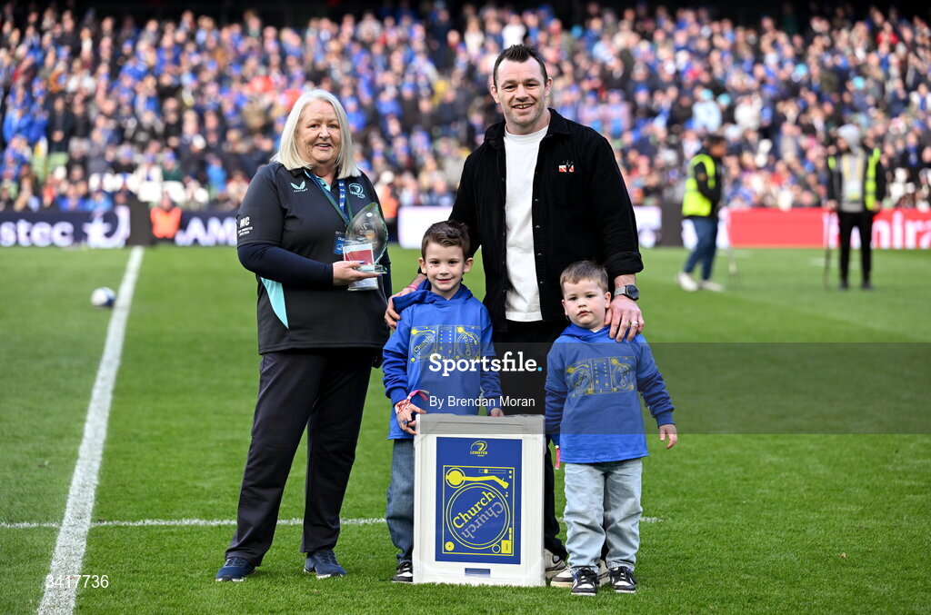 5 April 2026; OLSC committee member Mary Carroll makes a presentation to record Leinster cap holder Cian Healy, accompanied by his sons Russell and Beau, at half-time in the Investec Champions Cup match between Leinster and Edinburgh at the Aviva Stadium in Dublin. Photo by Brendan Moran/Sportsfile