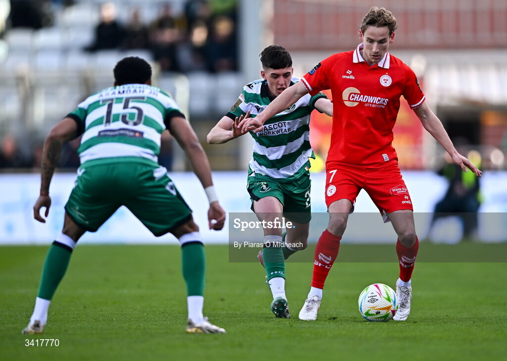 6 April 2026; Harry Wood of Shelbourne in action against Cory O'Sullivan and Maleace Asamoah, 15, of Shamrock Rovers during the SSE Airtricity Men's Premier Division match between Shamrock Rovers and Shelbourne at Tallaght Stadium in Dublin. Photo by Piaras Ó Mídheach/Sportsfile