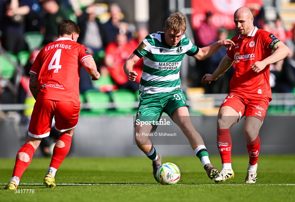 6 April 2026; Michael Noonan of Shamrock Rovers in action against Kameron Ledwidge, left, and Tyreke Wilson of Shelbourne during the SSE Airtricity Men's Premier Division match between Shamrock Rovers and Shelbourne at Tallaght Stadium in Dublin. Photo by Piaras Ó Mídheach/Sportsfile