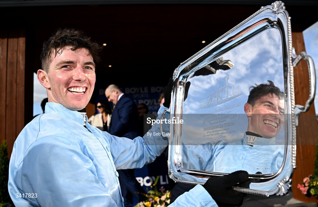 6 April 2026; Jockey Donagh Meyler celebrates with the trophy after winning the BOYLE Sports Irish Grand National Steeplechase on Soldier In Milan during day three of the Fairyhouse Easter Festival at Fairyhouse Racecourse in Ratoath, Meath. Photo by Seb Daly/Sportsfile