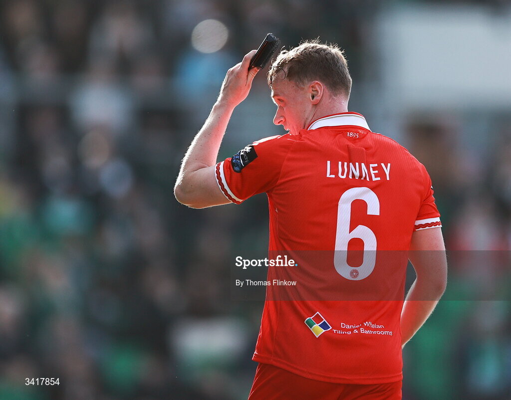 6 April 2026; JJ Lunney of Shelbourne pretends to brush his hair with a hairbrush thrown onto the pitch following his side's first goal during the SSE Airtricity Men's Premier Division match between Shamrock Rovers and Shelbourne at Tallaght Stadium in Dublin. Photo by Thomas Flinkow/Sportsfile