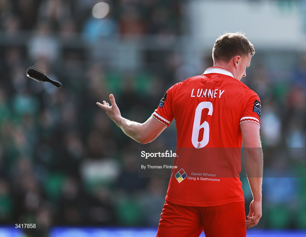 6 April 2026; JJ Lunney of Shelbourne throws away a hairbrush that was thrown onto the pitch following his side's first goal during the SSE Airtricity Men's Premier Division match between Shamrock Rovers and Shelbourne at Tallaght Stadium in Dublin. Photo by Thomas Flinkow/Sportsfile