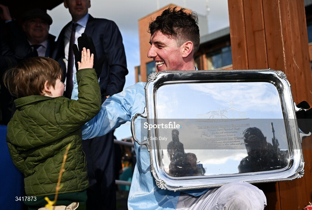 6 April 2026; Jockey Donagh Meyler is congratulated by his nephew Jim Kelleher, age 3, after winning the BOYLE Sports Irish Grand National Steeplechase on Soldier In Milan during day three of the Fairyhouse Easter Festival at Fairyhouse Racecourse in Ratoath, Meath. Photo by Seb Daly/Sportsfile