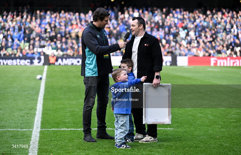 5 April 2026; Leinster record cap holder Cian Healy, accompanied by his sons Russell and Beau, is interviewed by MC Mike McCarthy, during half-time in the Investec Champions Cup match between Leinster and Edinburgh at the Aviva Stadium in Dublin. Photo by Brendan Moran/Sportsfile