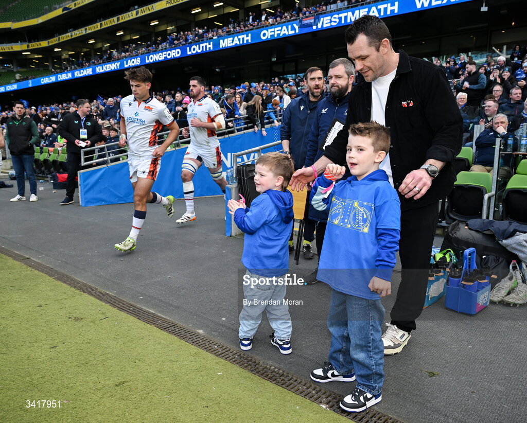 5 April 2026; Leinster record cap holder Cian Healy, accompanied by his sons Russell and Beau, watch Edinburgh run onto the pitch for the second half of the Investec Champions Cup match between Leinster and Edinburgh at the Aviva Stadium in Dublin. Photo by Brendan Moran/Sportsfile
