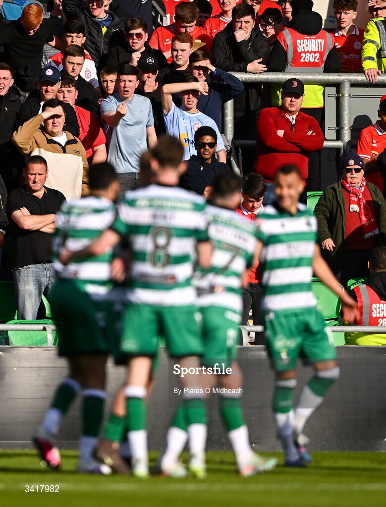 6 April 2026; (EDITOR'S NOTE; Image contains profanity) Shelbourne supporters react as Shamrock Rovers players celebrate their side's second goal, scored by Michael Noonan, during the SSE Airtricity Men's Premier Division match between Shamrock Rovers and Shelbourne at Tallaght Stadium in Dublin. Photo by Piaras Ó Mídheach/Sportsfile