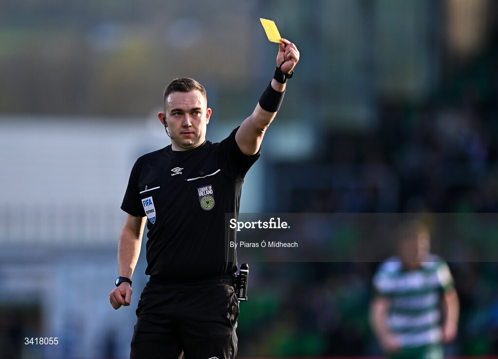 6 April 2026; Referee Kevin O'Sullivan shows the yellow card during the SSE Airtricity Men's Premier Division match between Shamrock Rovers and Shelbourne at Tallaght Stadium in Dublin. Photo by Piaras Ó Mídheach/Sportsfile