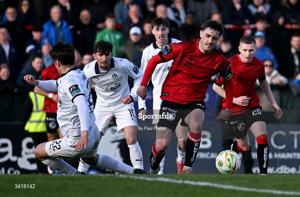 6 April 2026; Ronan Mansfield of Waterford fouls Dawson Devoy of Bohemians to concede a penalty during the SSE Airtricity Men's Premier Division match between Bohemians and Waterford at Dalymount Park in Dublin. Photo by Paul Phelan/Sportsfile
