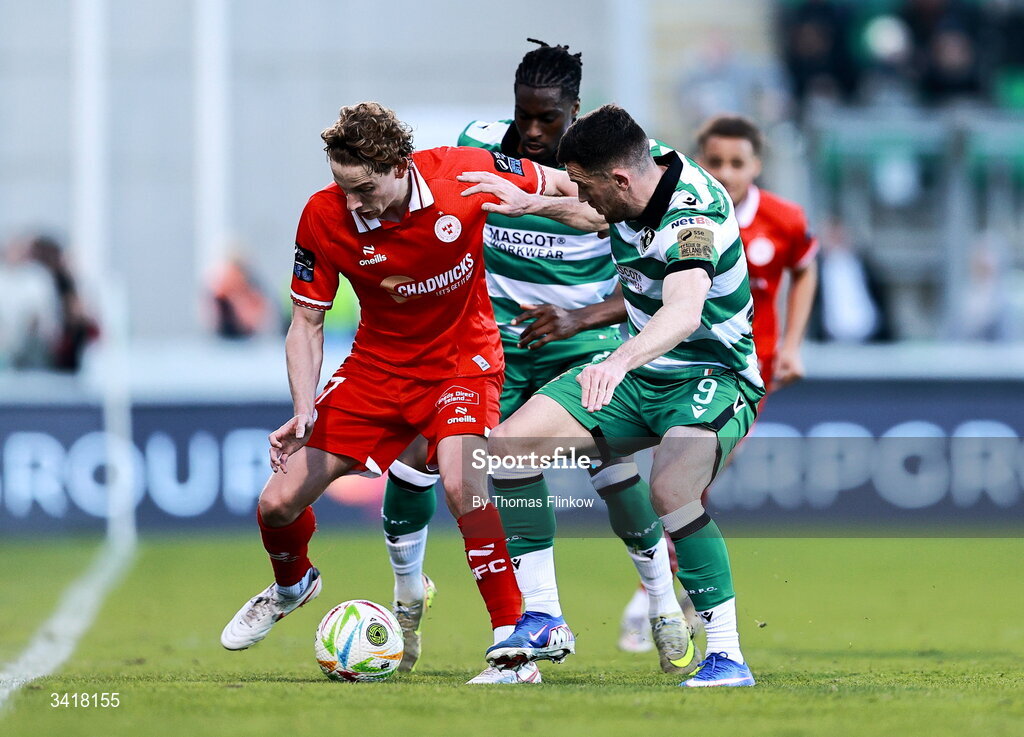 6 April 2026; Harry Wood of Shelbourne in action against Shamrock Rovers players Aaron Greene, front, and Tunmise Sobowale during the SSE Airtricity Men's Premier Division match between Shamrock Rovers and Shelbourne at Tallaght Stadium in Dublin. Photo by Thomas Flinkow/Sportsfile