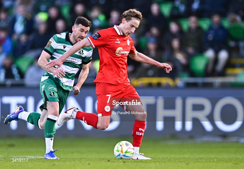 6 April 2026; Harry Wood of Shelbourne in action against Aaron Greene of Shamrock Rovers during the SSE Airtricity Men's Premier Division match between Shamrock Rovers and Shelbourne at Tallaght Stadium in Dublin. Photo by Piaras Ó Mídheach/Sportsfile