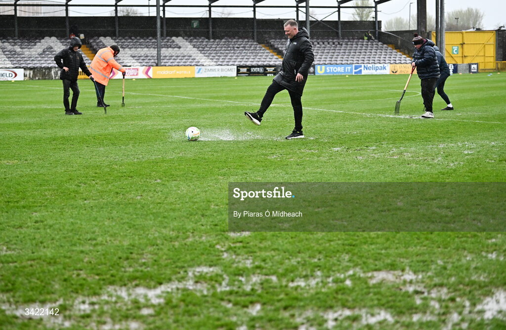 10 April 2026; Fourth official Mark Houlihan kicks a footall as he inspects the wet pitch before the SSE Airtricity Men's Premier Division match between Galway United and Shelbourne at Eamonn Deacy Park in Galway. Photo by Piaras Ó Mídheach/Sportsfile