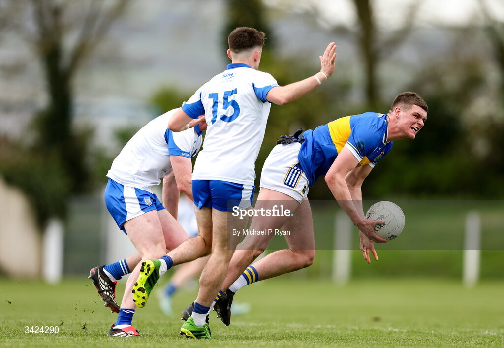 12 April 2026; Joe Higgins of Tipperary is tackled by Michael Curry, left, and Alan Dunwoody of Waterford during the Munster GAA Football Senior Championship quarter-final match between Waterford and Tipperary at Cappoquin Logistics Fraher Field in Waterford. Photo by Michael P Ryan/Sportsfile