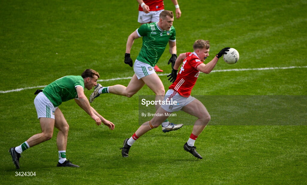 12 April 2026; Dara Sheedy of Cork gets away from Eliah Riordan and Killian Ryan of Limerick on theway to scoring his side's first goal during the Munster GAA Football Senior Championship quarter-final match between Cork and Limerick at SuperValu Páirc Uí Chaoimh in Cork. Photo by Brendan Moran/Sportsfile