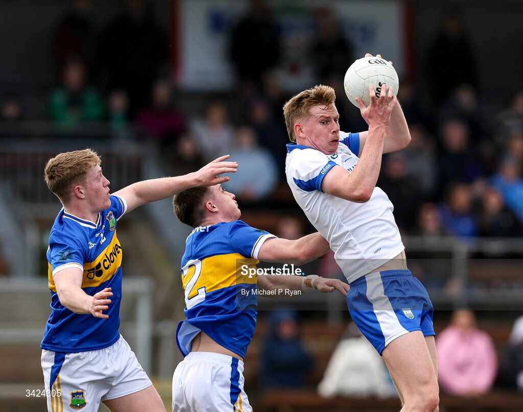 12 April 2026; Michael O'Brien of Waterford in action against Jack O'Neill, left, and Killian Butler of Tipperary during the Munster GAA Football Senior Championship quarter-final match between Waterford and Tipperary at Cappoquin Logistics Fraher Field in Waterford. Photo by Michael P Ryan/Sportsfile