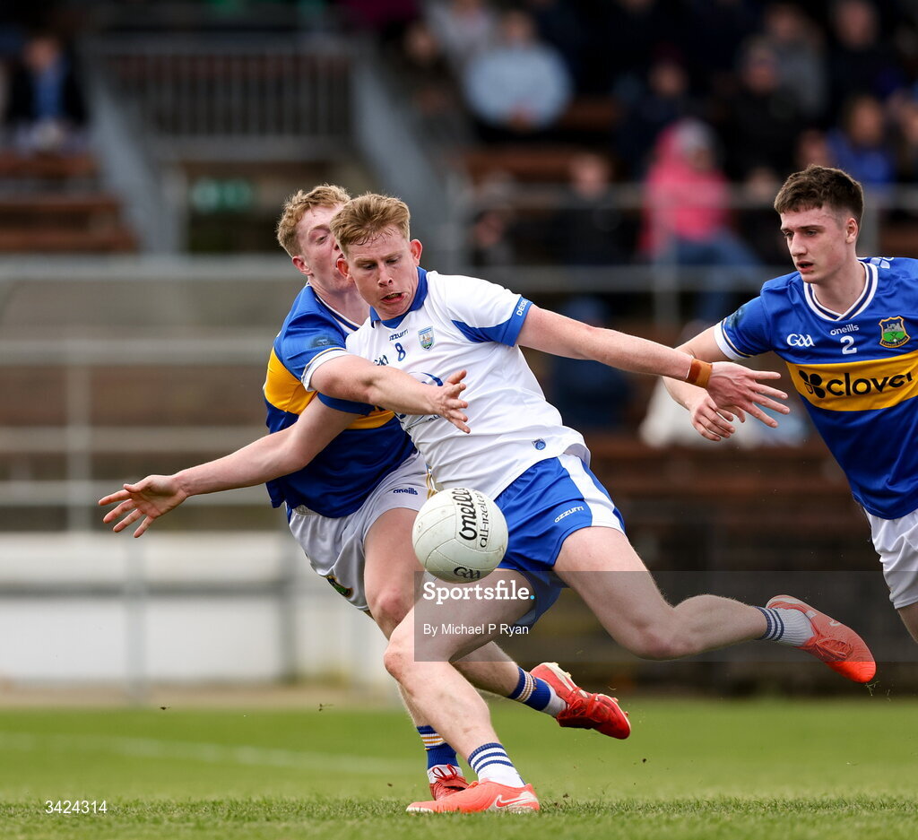 12 April 2026; Michael O'Brien of Waterford shoots to score his side's first goal despite the attention of Killian Butler of Tipperary during the Munster GAA Football Senior Championship quarter-final match between Waterford and Tipperary at Cappoquin Logistics Fraher Field in Waterford. Photo by Michael P Ryan/Sportsfile