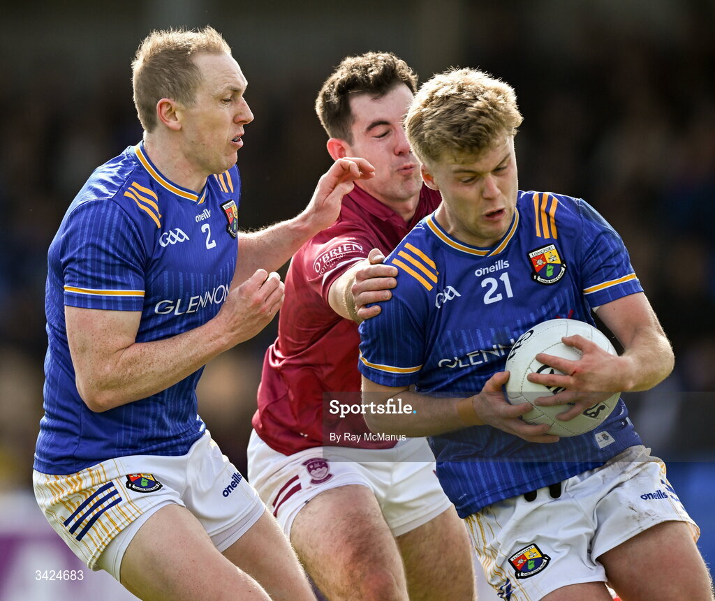 12 April 2026; Matthew Flynn with Patrick Fox of Longford, left, combine to clear the ball away from Sam McCartan of Westmeath during the Leinster GAA Football Senior Championship Round 1 match between Longford and Westmeath at Glennon Bros Pearse Park in Longford. Photo by Ray McManus/Sportsfile