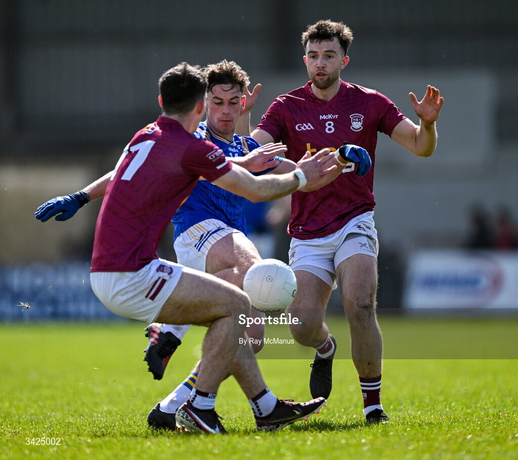 12 April 2026; Joseph Hagan of Longford fires in a shot under pressure from Westmeath players Sam McCartan and Brían Cooney, right, during the Leinster GAA Football Senior Championship Round 1 match between Longford and Westmeath at Glennon Bros Pearse Park in Longford. Photo by Ray McManus/Sportsfile