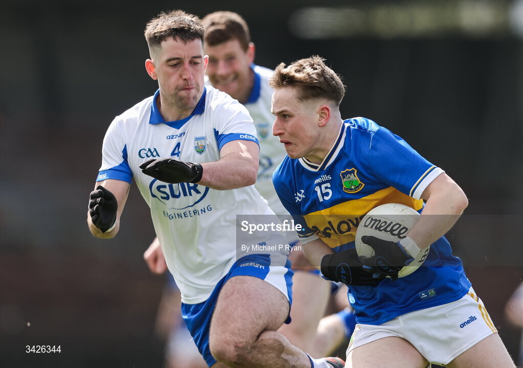 12 April 2026; Daithi Hogan of Tipperary in action against Conor Ó Cuirrín of Waterford during the Munster GAA Football Senior Championship quarter-final match between Waterford and Tipperary at Cappoquin Logistics Fraher Field in Waterford. Photo by Michael P Ryan/Sportsfile
