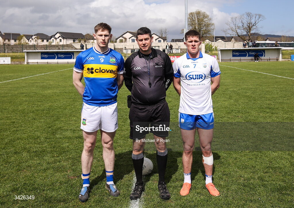 12 April 2026; Referee Barry Tiernan with team captains Paudie Feehan of Tipperary, left, and Conor Murray of Waterford before the Munster GAA Football Senior Championship quarter-final match between Waterford and Tipperary at Cappoquin Logistics Fraher Field in Waterford. Photo by Michael P Ryan/Sportsfile
