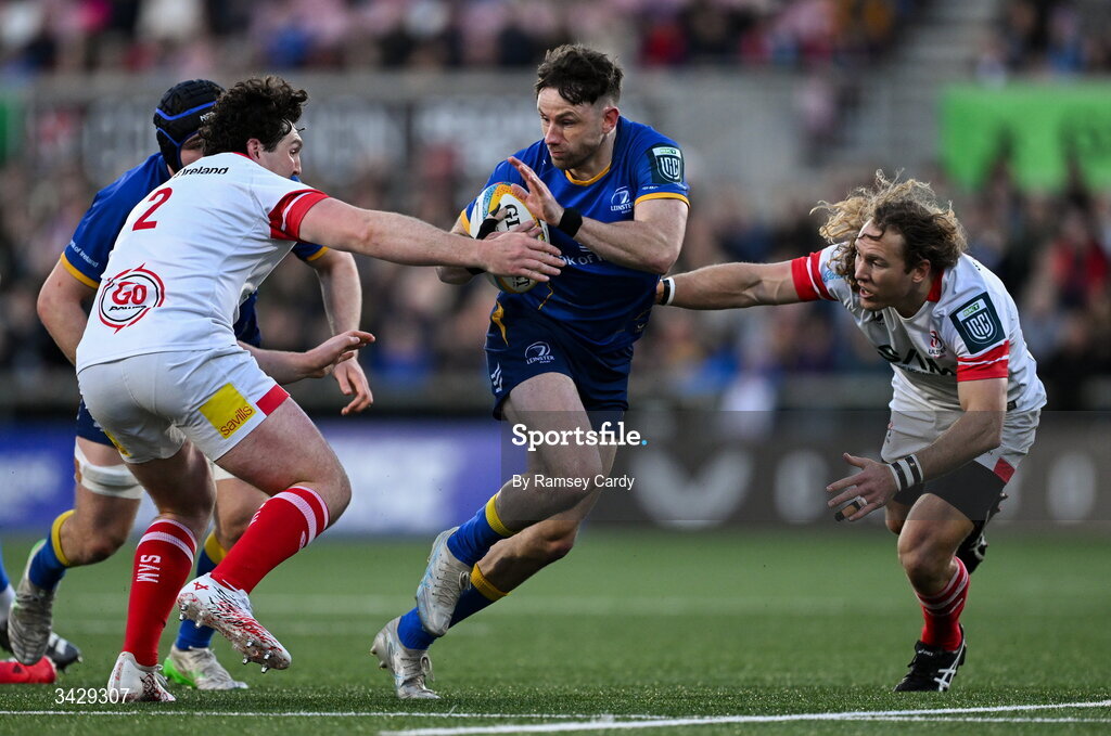 17 April 2026; Hugo Keenan of Leinster is tackled by Tom Stewart, left, and Werner Kok of Ulster during the United Rugby Championship match between Ulster and Leinster at Affidea Stadium in Belfast. Photo by Ramsey Cardy/Sportsfile