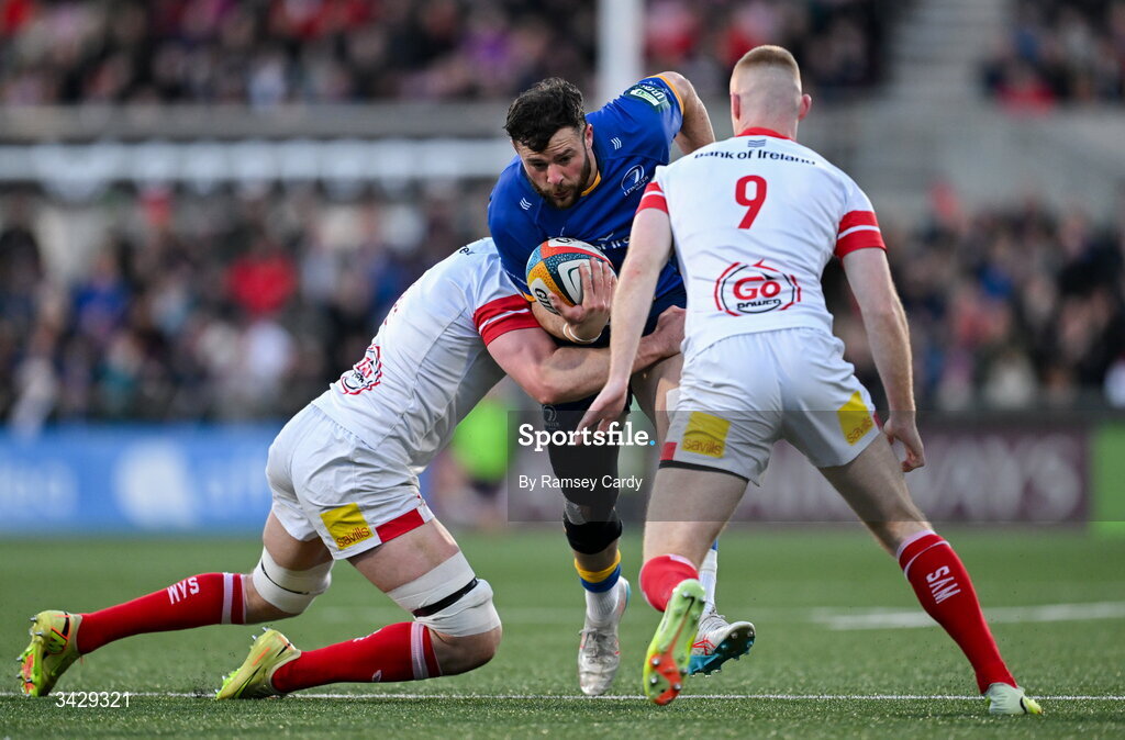 17 April 2026; Robbie Henshaw of Leinster is tackled by David McCann and Nathan Doak of Ulster during the United Rugby Championship match between Ulster and Leinster at Affidea Stadium in Belfast. Photo by Ramsey Cardy/Sportsfile