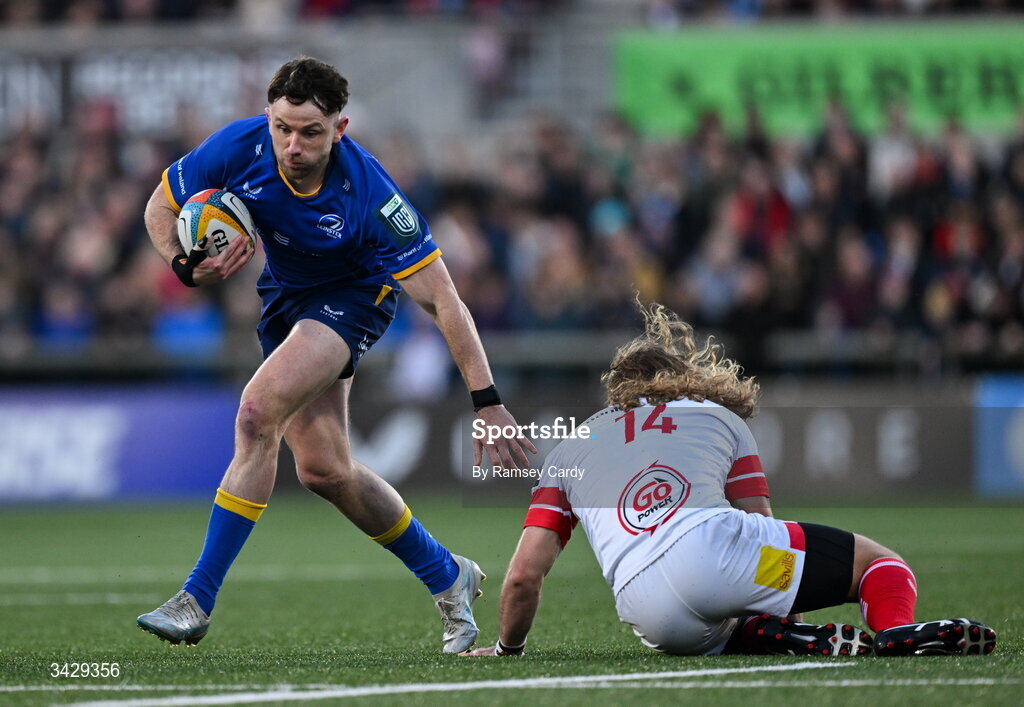 17 April 2026; Hugo Keenan of Leinster evades the tackle of Werner Kok of Ulster during the United Rugby Championship match between Ulster and Leinster at Affidea Stadium in Belfast. Photo by Ramsey Cardy/Sportsfile