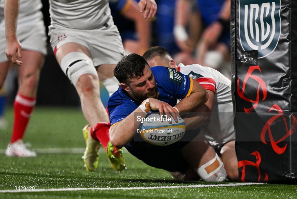17 April 2026; Robbie Henshaw of Leinster scores his side's third try despite the tackle from Stuart McCloskey of Ulster during the United Rugby Championship match between Ulster and Leinster at Affidea Stadium in Belfast. Photo by David Fitzgerald/Sportsfile