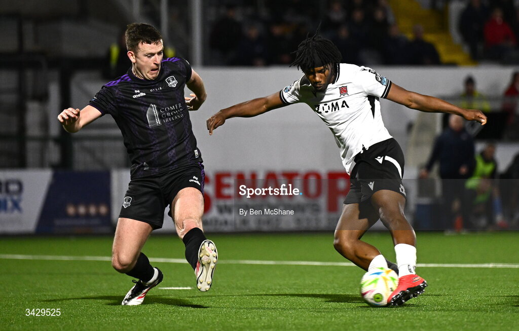 17 April 2026; Gbemi Arubi of Dundalk has a shot on goal despite the tackle of Killian Brouder of Galway United during the SSE Airtricity Men's Premier Division match between Dundalk and Galway United at Oriel Park in Dundalk, Louth. Photo by Ben McShane/Sportsfile