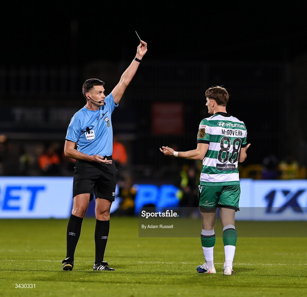 17 April 2026; John McGovern of Shamrock Rovers is shown a yellow card by referee Rob Hennessy during the SSE Airtricity Men's Premier Division match between Shamrock Rovers and Bohemians at Tallaght Stadium in Dublin. Photo by Adam Russell/Sportsfile