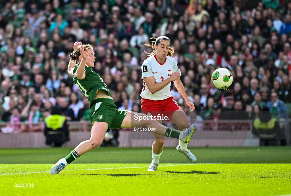 18 April 2026; Emily Murphy of Republic of Ireland has a shot at goal under pressure from Wiktoria Zieniewicz of Poland during the 2027 FIFA Women’s World Cup Qualifier match between Republic of Ireland and Poland at the Aviva Stadium in Dublin. Photo by Seb Daly/Sportsfile