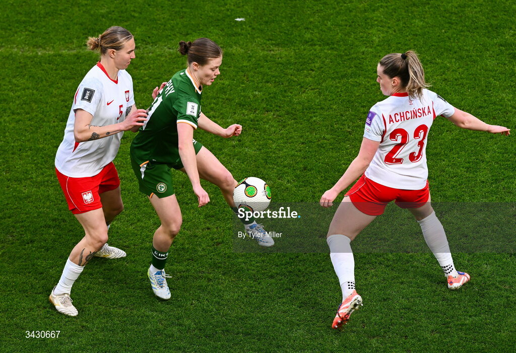18 April 2026; Emily Murphy of Republic of Ireland in action against Oliwia Wos, left, and Adriana Achcinska of Poland during the 2027 FIFA Women’s World Cup Qualifier match between Republic of Ireland and Poland at the Aviva Stadium in Dublin. Photo by Tyler Miller/Sportsfile