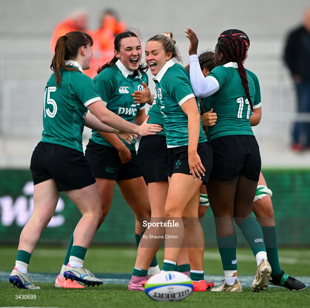 18 April 2026; Katie Corrigan of Ireland, centre, is congratulated by team-mates after scoring their side's sixth try during the Women's U21 Six Nations Series match between Ireland and Italy at Dexcom Stadium in Galway. Photo by Shauna Clinton/Sportsfile