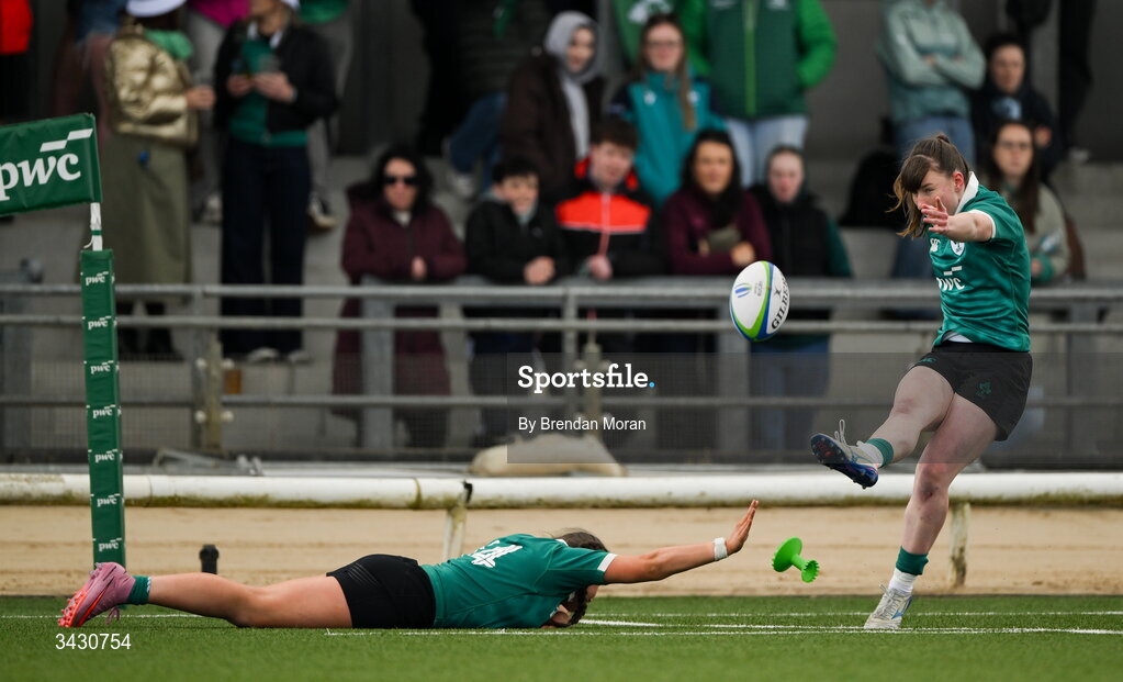 18 April 2026; Niamh Gallagher of Ireland kicks a conversion, with the help of teammate Katie Corrigan, during the Women's U21 Six Nations Series match between Ireland and Italy at Dexcom Stadium in Galway. Photo by Brendan Moran/Sportsfile