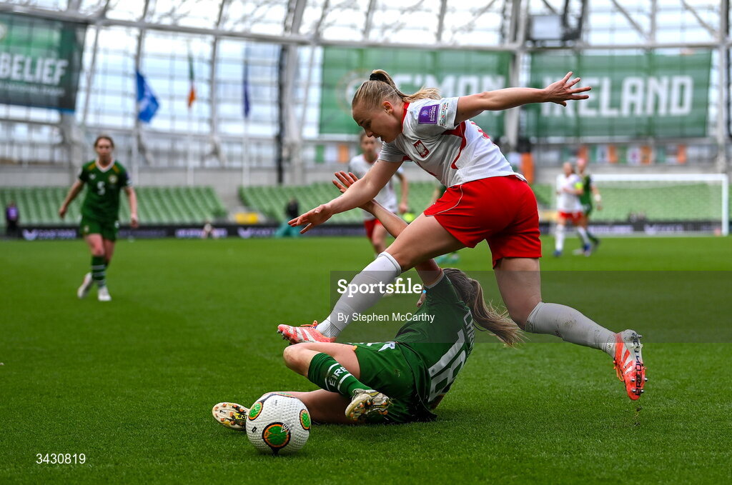 18 April 2026; Paulina Dudek of Poland is tackled by Kyra Carusa of Republic of Ireland during the 2027 FIFA Women’s World Cup Qualifier match between Republic of Ireland and Poland at the Aviva Stadium in Dublin. Photo by Stephen McCarthy/Sportsfile