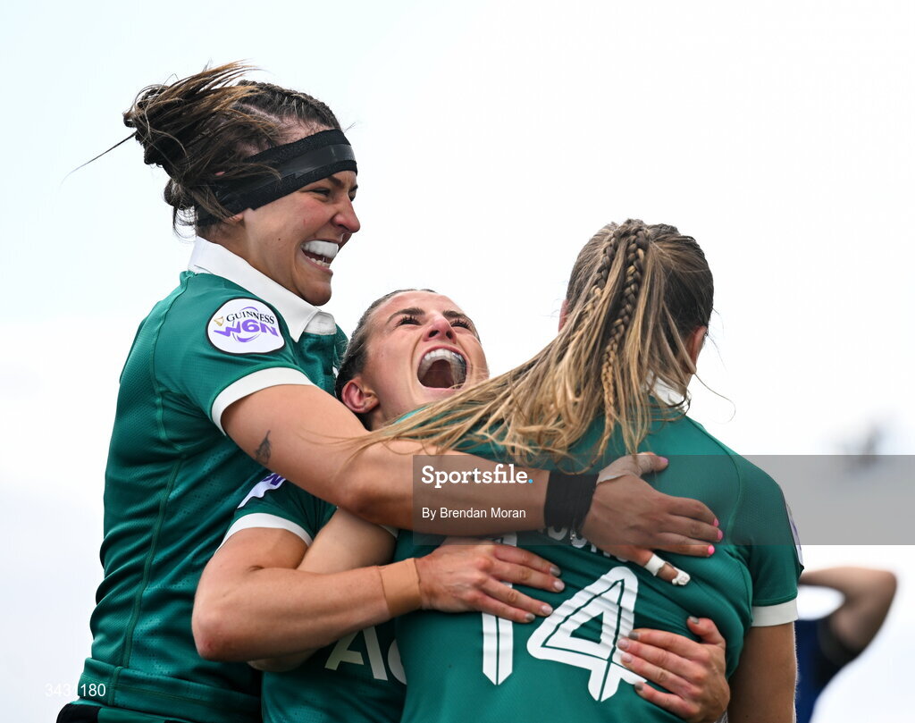 18 April 2026; Béibhinn Parsons of Ireland, 14, celebrates with teammates, Erin King, left, and Emily Lane after scoring her second try during the Women's Six Nations Rugby Championship match between Ireland and Italy at Dexcom Stadium in Galway. Photo by Brendan Moran/Sportsfile