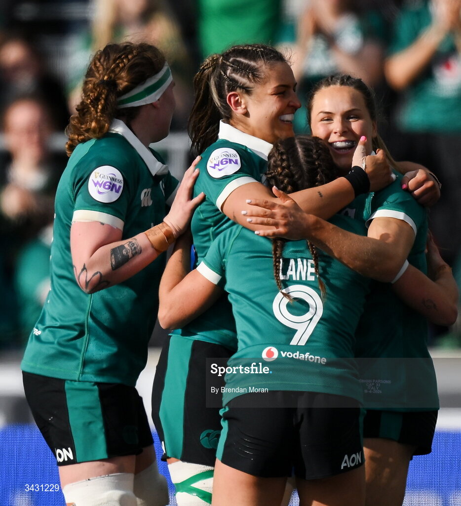 18 April 2026; Béibhinn Parsons of Ireland, right, celebrates with teammates Ruth Campbell, Erin King and Emily Lane after scoring her third try during the Women's Six Nations Rugby Championship match between Ireland and Italy at Dexcom Stadium in Galway. Photo by Brendan Moran/Sportsfile