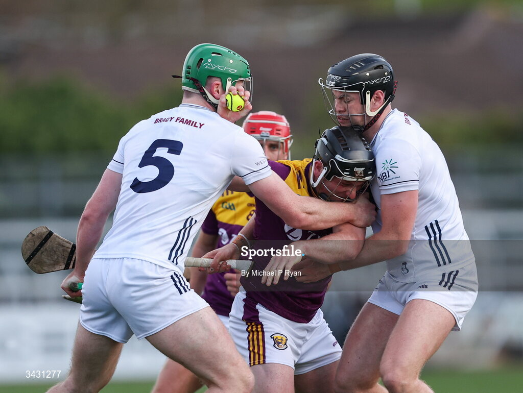 18 April 2026; Kevin Foley of Wexford is tackled by Paul Dolan, left, anf Cathal McCabe of Kildare during the Leinster GAA Senior Hurling Championship Round 1 match between Kildare and Wexford at Cedral St Conleth's Park in Newbridge, Kildare. Photo by Michael P Ryan/Sportsfile