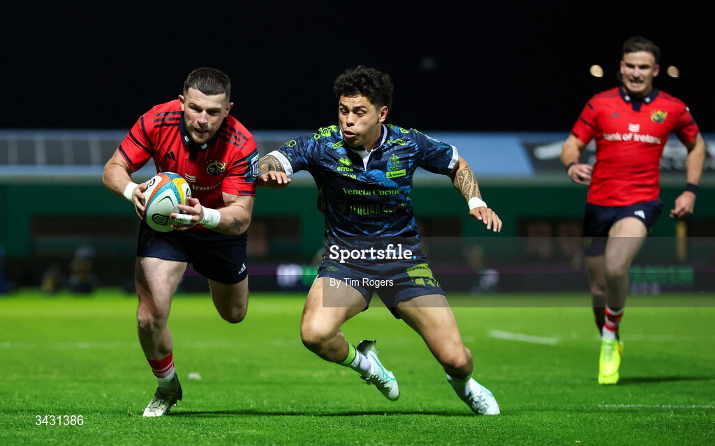 18 April 2026; Calvin Nash of Munster breaks past Jacob Umaga of Benetton before scoring his team's first try during the United Rugby Championship match between Benetton and Munster at Stadio Monigo in Treviso, Italy. Photo by Tim Rogers/Sportsfile
