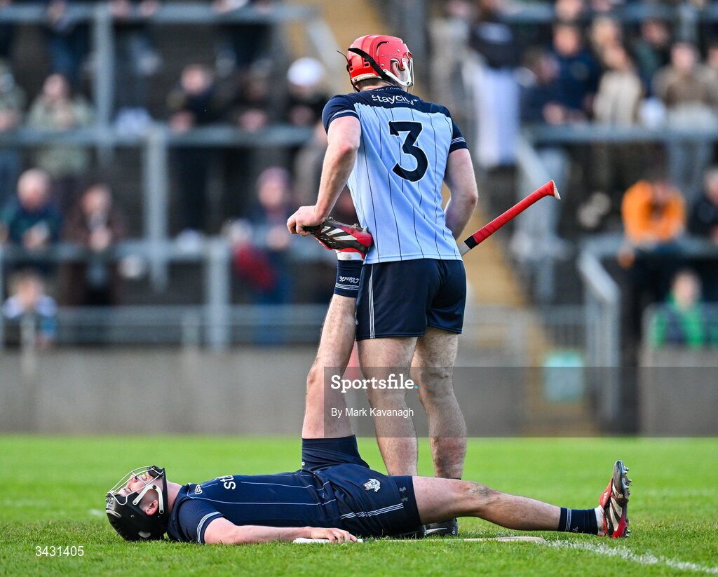 18 April 2026; Paddy Smyth of Dublin assists Dublin goalkeeper Seán Brennan with a calf cramp during the Leinster GAA Senior Hurling Championship Round 1 match between Offaly and Dublin at Glenisk O'Connor Park in Tullamore, Offaly. Photo by Mark Kavanagh/Sportsfile