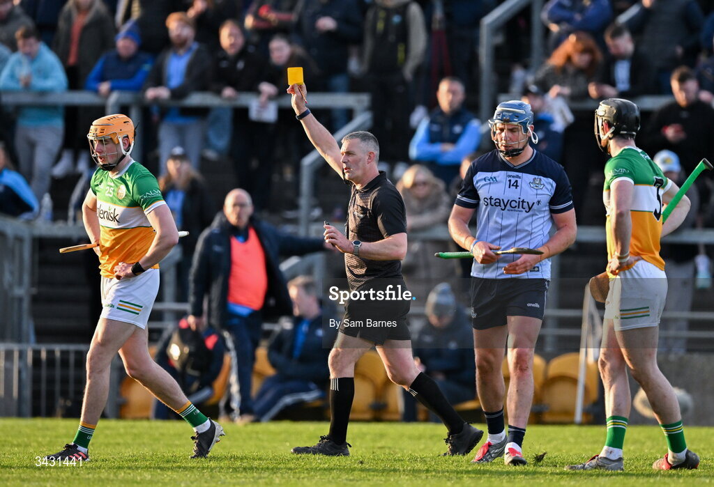 18 April 2026; Referee James Owens shows a yellow card to Ciaran Burke of Offaly, left, and John Hetherton of Dublin, second from right, during the Leinster GAA Senior Hurling Championship Round 1 match between Offaly and Dublin at Glenisk O'Connor Park in Tullamore, Offaly. Photo by Sam Barnes/Sportsfile
