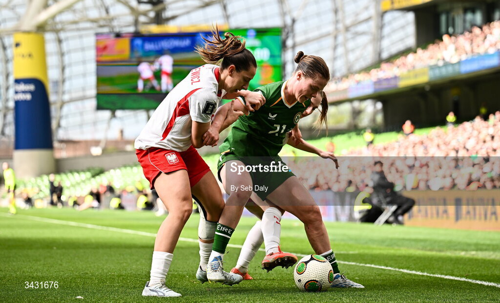 18 April 2026; Emily Murphy of Republic of Ireland in action against Poland players Wiktoria Zieniewicz, left, and Gabriela Grzybowska during the 2027 FIFA Women’s World Cup Qualifier match between Republic of Ireland and Poland at the Aviva Stadium in Dublin. Photo by Seb Daly/Sportsfile